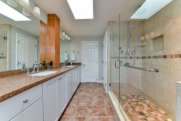 14 Farm Hill Road Natick, MA 01760 - Photo 16 of 27 a large bathroom with a granite countertop sink a toilet a mirror and shower