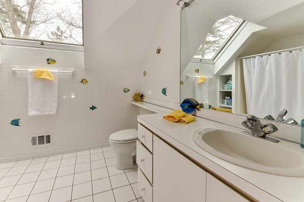 14 Farm Hill Road Natick, MA 01760 - Photo 18 of 27 a bathroom with a sink a toilet and mirror