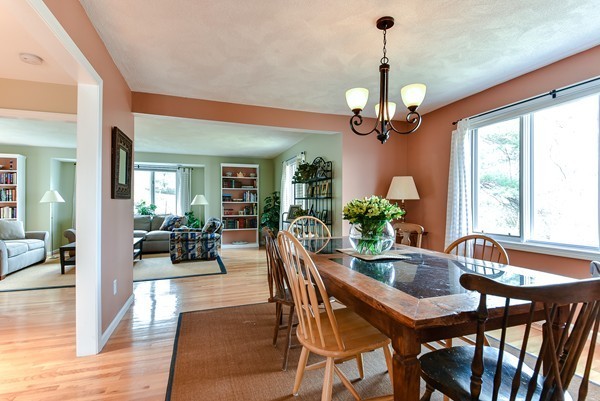 14 Farm Hill Road Natick, MA 01760 - Photo 5 of 27 a dining room with wooden floor a chandelier a wooden table and chairs