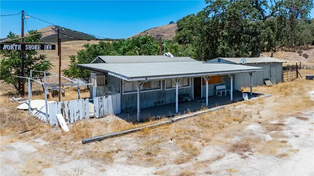 an aerial view of residential house with beach and outdoor space