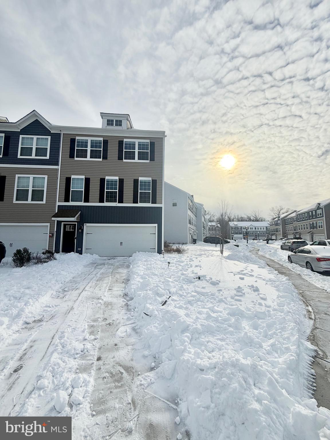 a view of a building with snow on the road