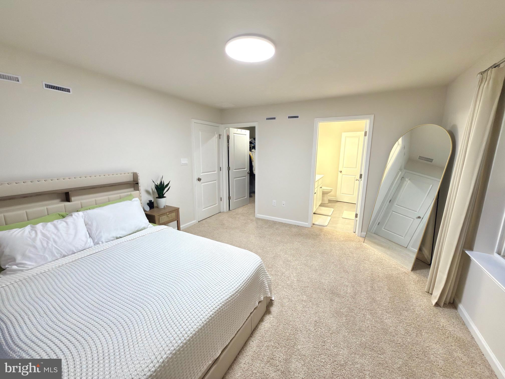 20 Stanton Rd Mount Mount Holly, NJ 08060 - Photo 15 of 25 a spacious bedroom with a bed and a large mirror