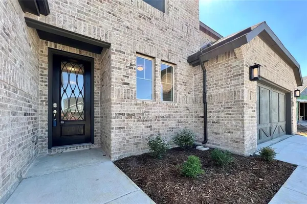 a view of a brick house with large windows