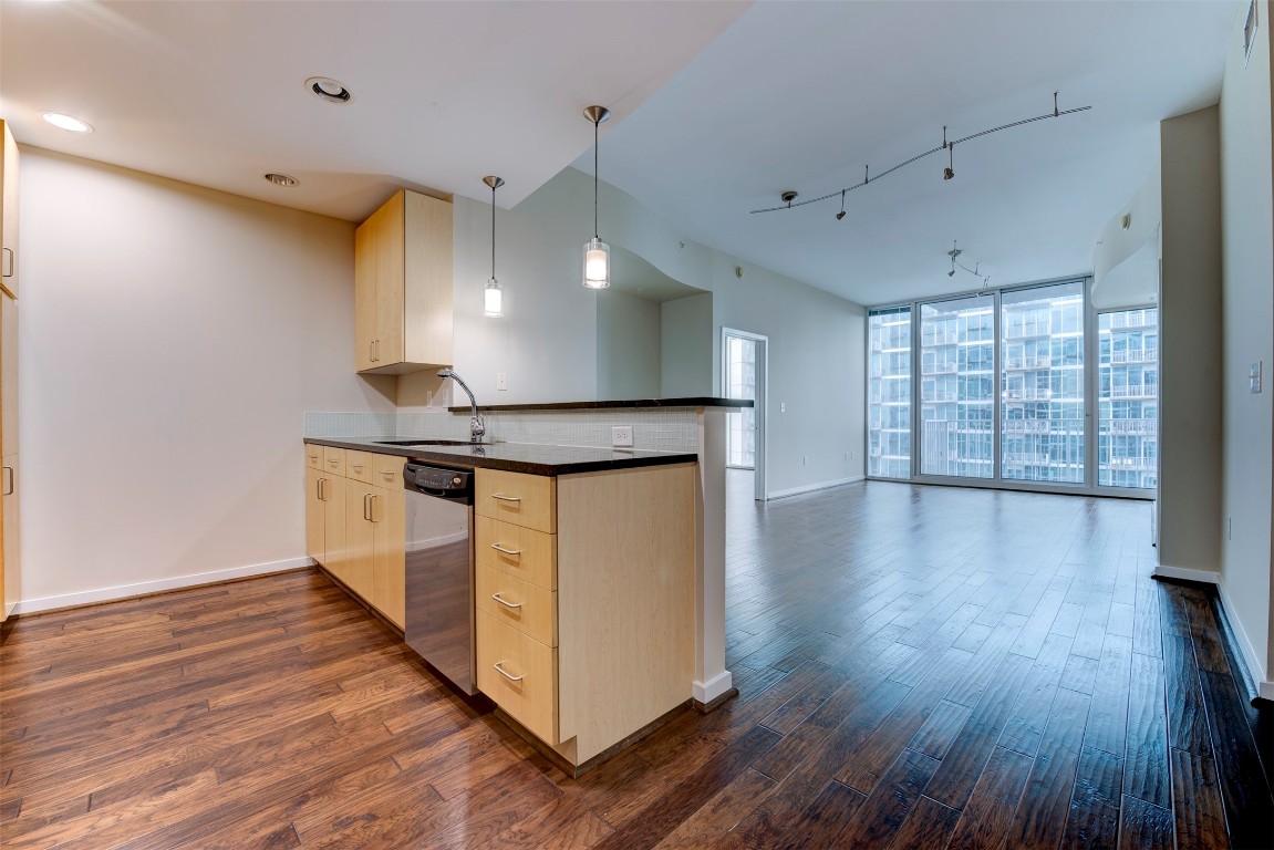5925 Almeda Road, Unit 2214 Houston, TX 77004 - Photo 1 of 34 a open kitchen with stainless steel appliances a large counter top a wooden floors and a large window