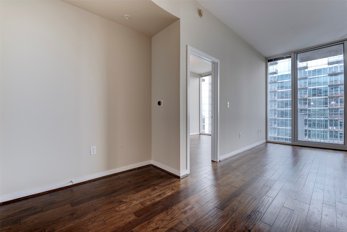 5925 Almeda Road, Unit 2214 Houston, TX 77004 - Photo 12 of 34 a view of an empty room with wooden floor and a window