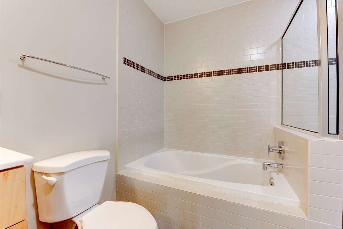 5925 Almeda Road, Unit 2214 Houston, TX 77004 - Photo 19 of 34 a white toilet sitting next to a bath tub