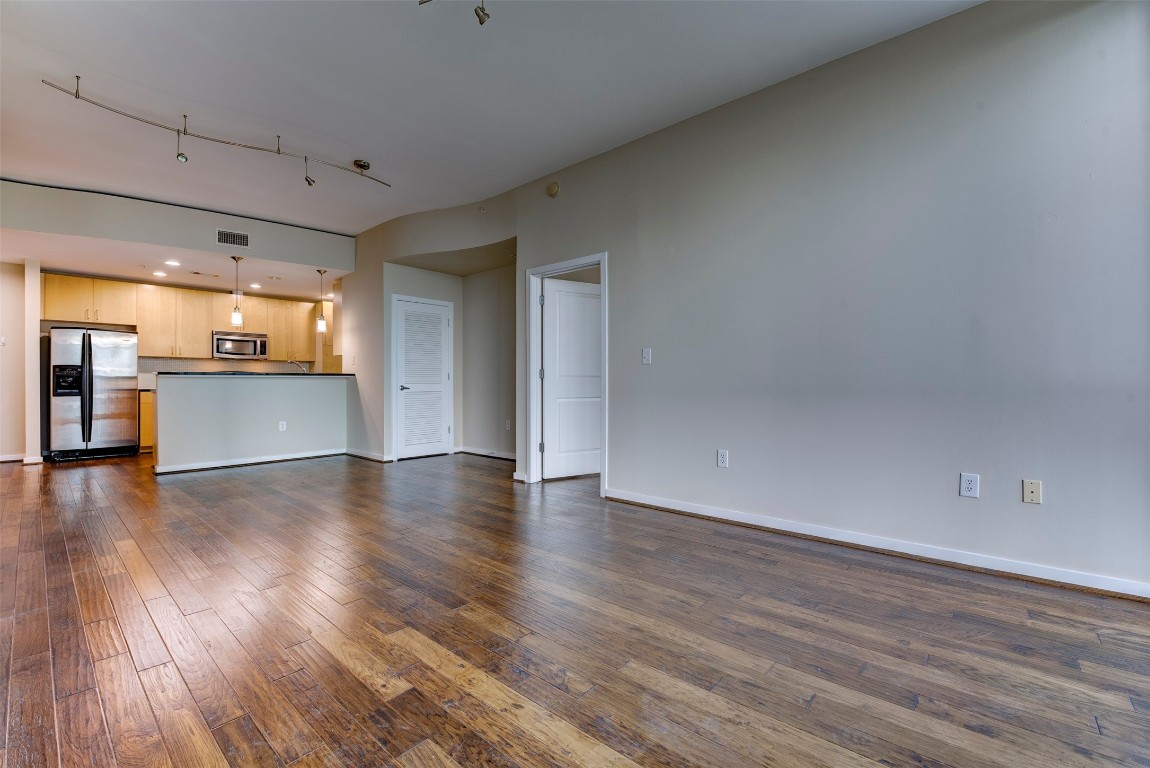 5925 Almeda Road, Unit 2214 Houston, TX 77004 - Photo 10 of 34 wooden floor in an empty room with a kitchen