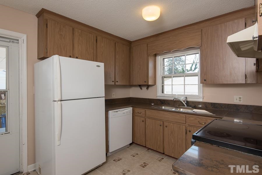 4120 Live Oak Road Raleigh, NC 27604 - Photo 8 of 25 a white refrigerator freezer sitting inside of a kitchen