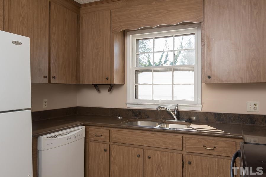 4120 Live Oak Road Raleigh, NC 27604 - Photo 9 of 25 a kitchen with sink cabinets and window
