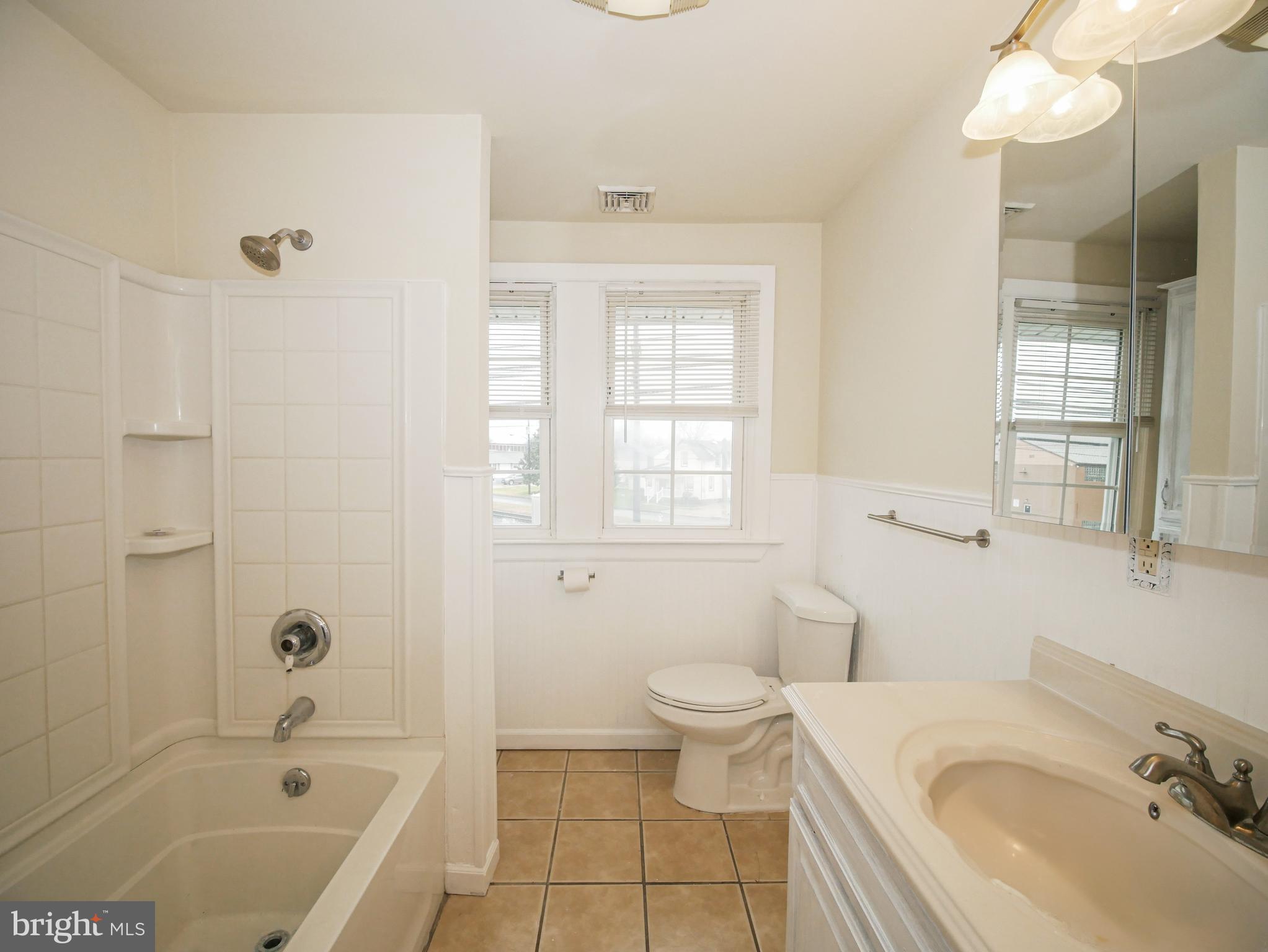 332 Crown Point Road Thorofare, NJ 08086 - Photo 25 of 36 a bathroom with a granite countertop sink a toilet and shower