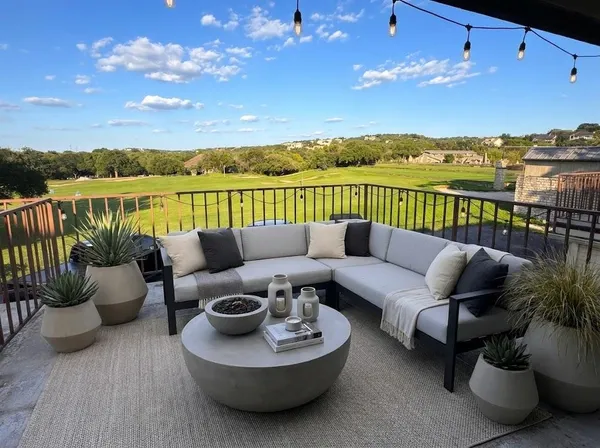 a balcony with furniture and city view