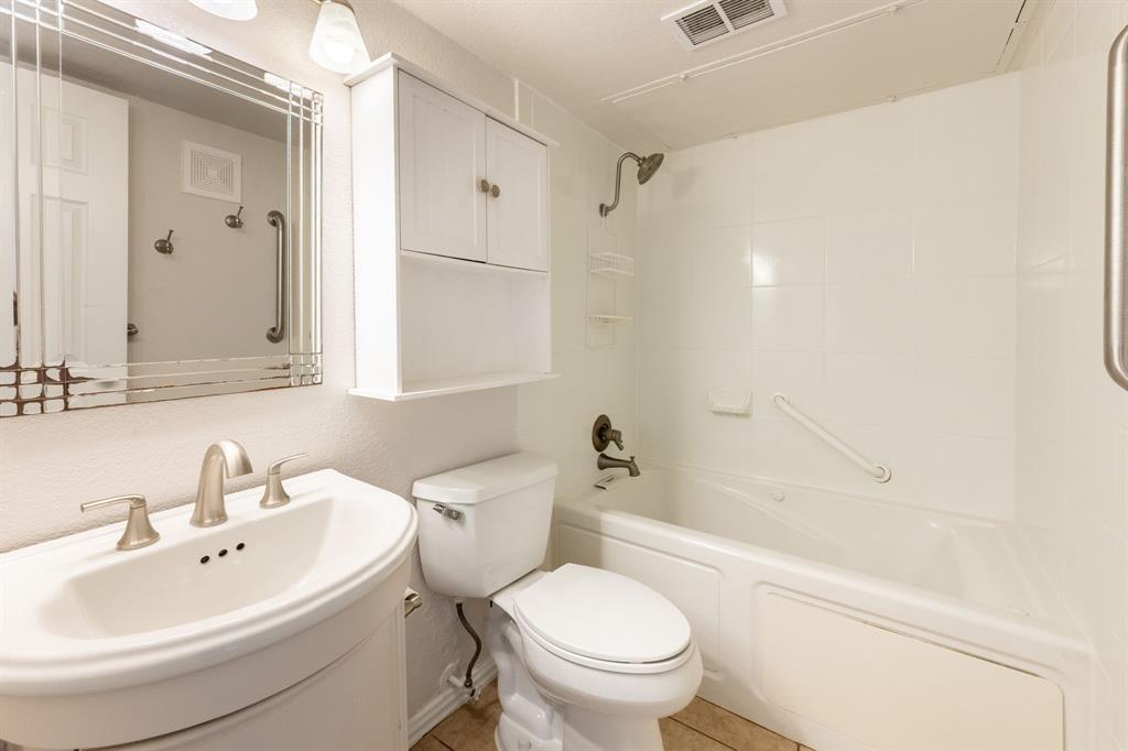 4610 Chaha Road, Unit 106 Garland, TX 75043 - Photo 16 of 25 a bathroom with a sink toilet and shower