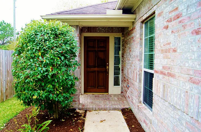 a front view of a house with a garden