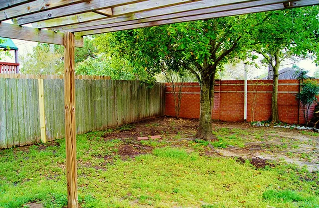 a backyard of a house with a garden and outdoor seating