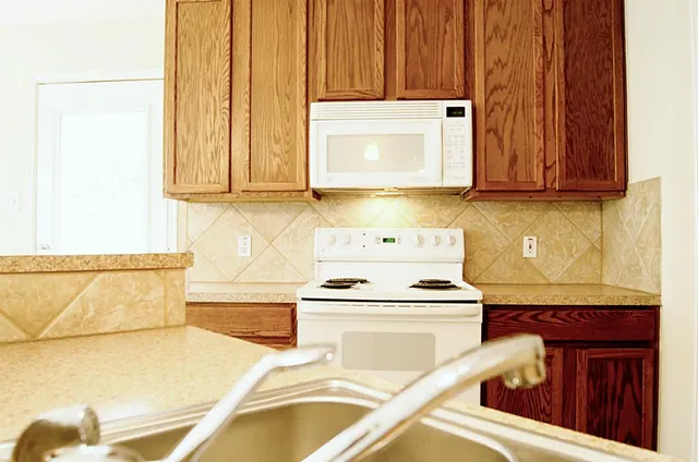 a kitchen with a stove and a microwave