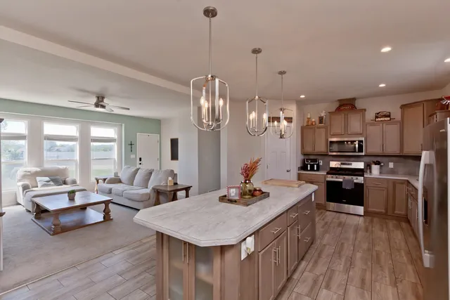 a large kitchen with sink a stove and a wooden floors