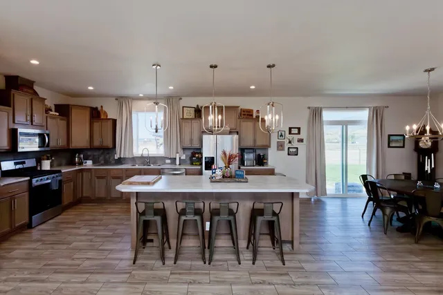 a large kitchen with a table and chairs