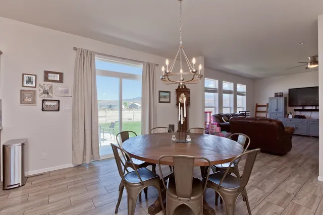 a view of a dining room with furniture a chandelier and wooden floor