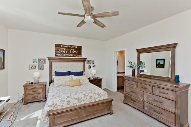 a bedroom with a bed and a dresser in it