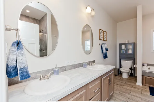 a bathroom with a double vanity sink and a mirror