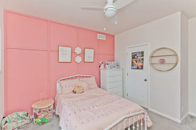 a bedroom with a bed and cabinets