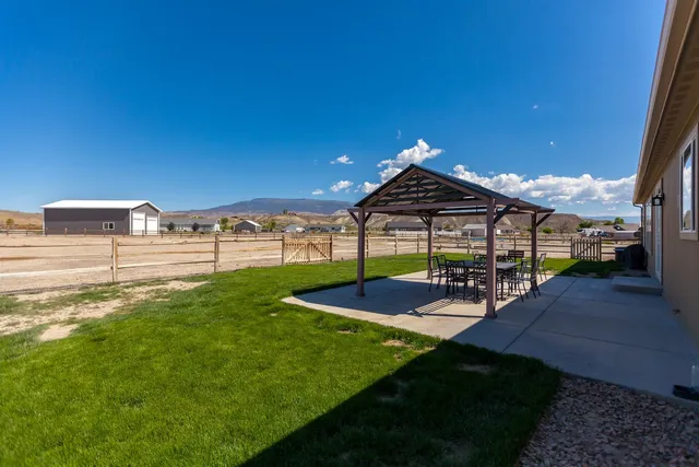 a view of a house with backyard and porch