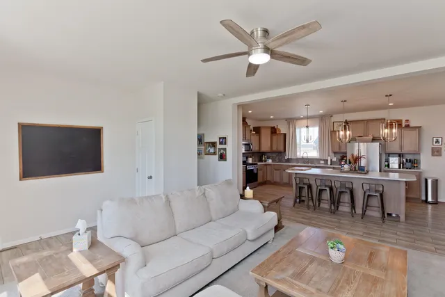 a living room with lots of furniture and view of kitchen
