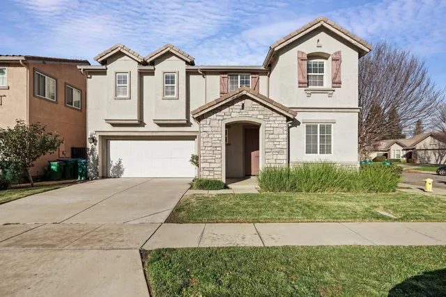 a view of a brick house with a yard