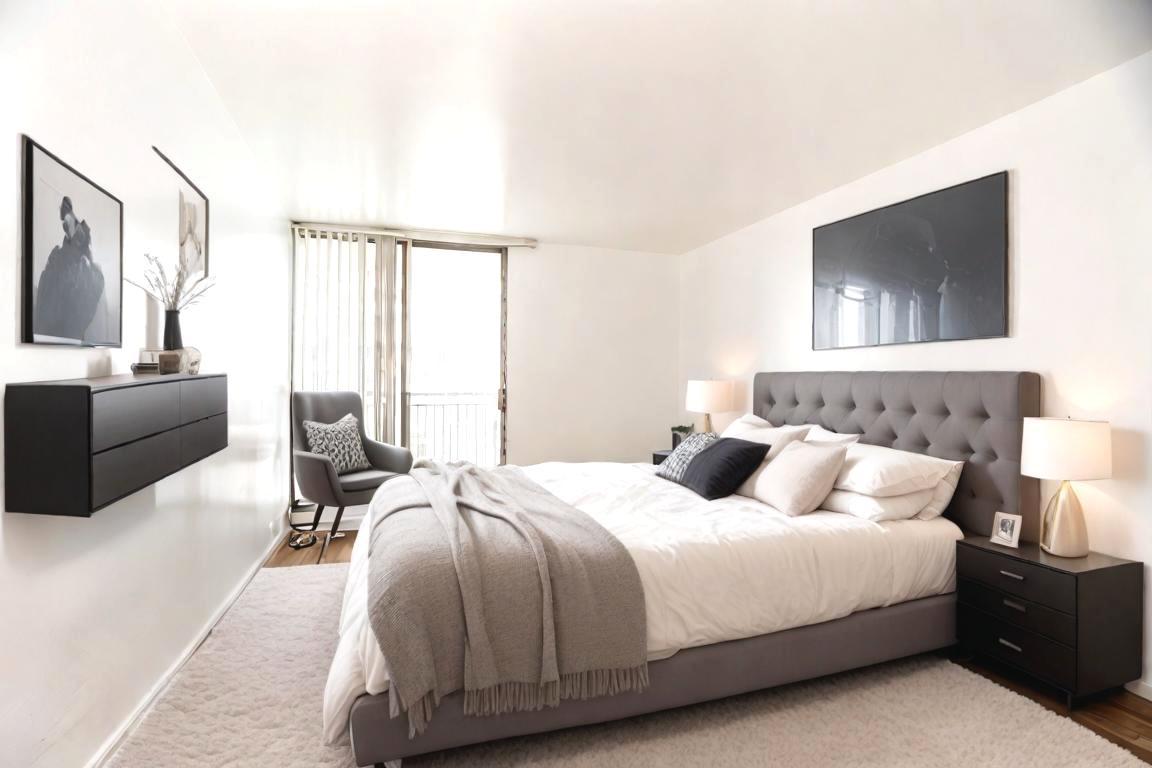 6007 North Sheridan Road, Unit 12D Chicago, IL 60660 - Photo 7 of 13 a bedroom with a bed and couch