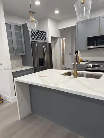 a kitchen with a refrigerator a sink and a stove