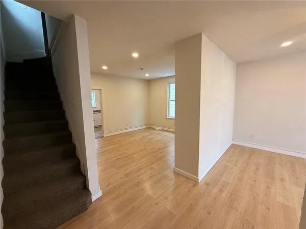 a view of a hallway with wooden floor