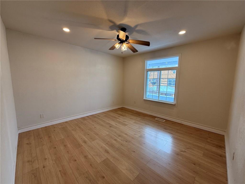 828 Frank Street McKees Rocks, PA 15136 - Photo 5 of 14 wooden floor in an empty room with a window
