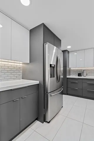 a kitchen with cabinets and stainless steel appliances