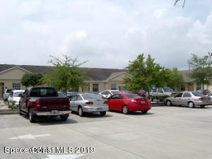 3150 North Wickham Road, Unit 2 Melbourne, FL 32935 - Photo 5 of 7 a view of a cars parked in front of a house