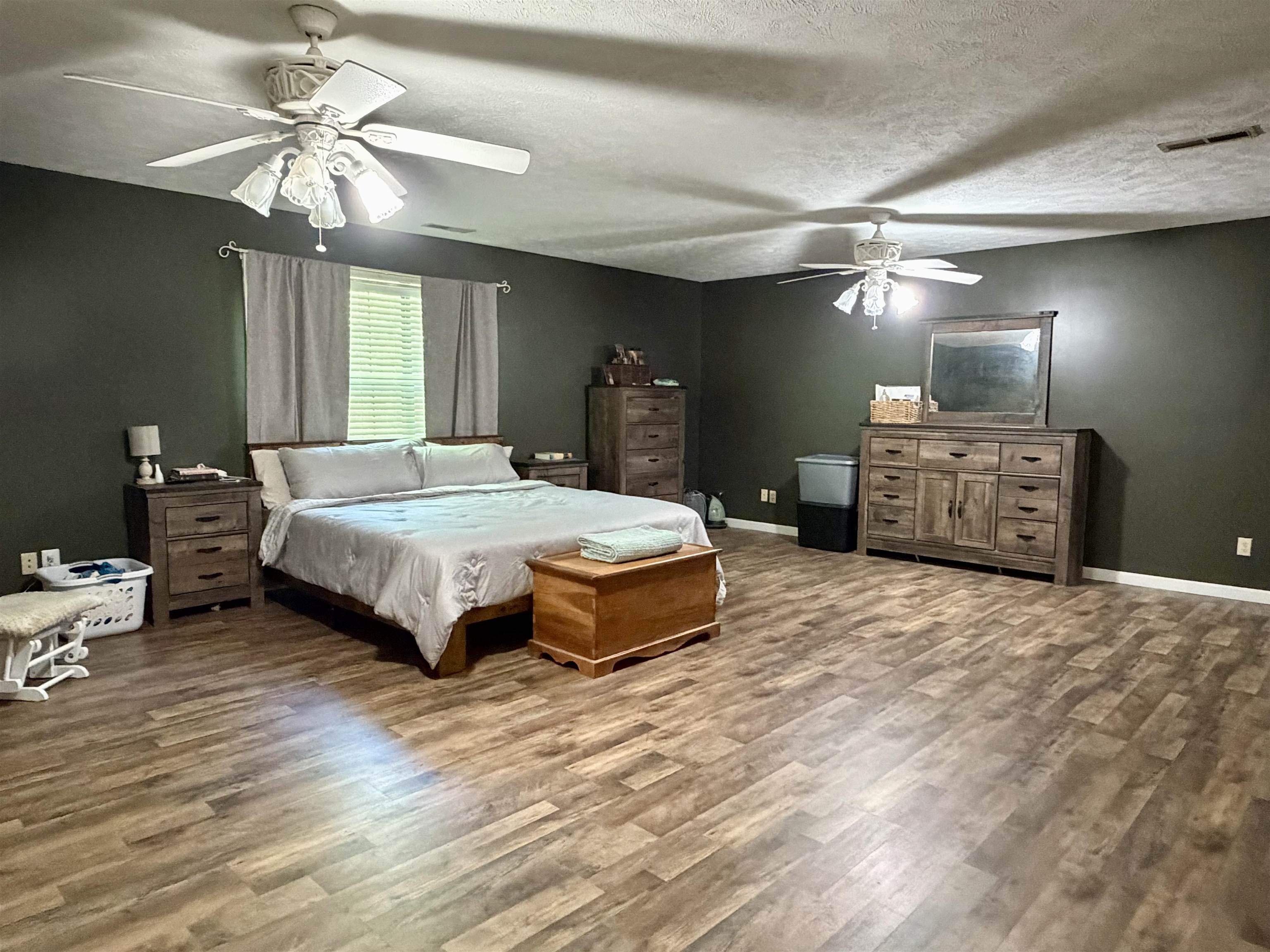 1536 Robinson Shed Road Bethel Springs, TN 38315 - Photo 13 of 23 Spacious room featuring wood-finish flooring and dark-toned walls