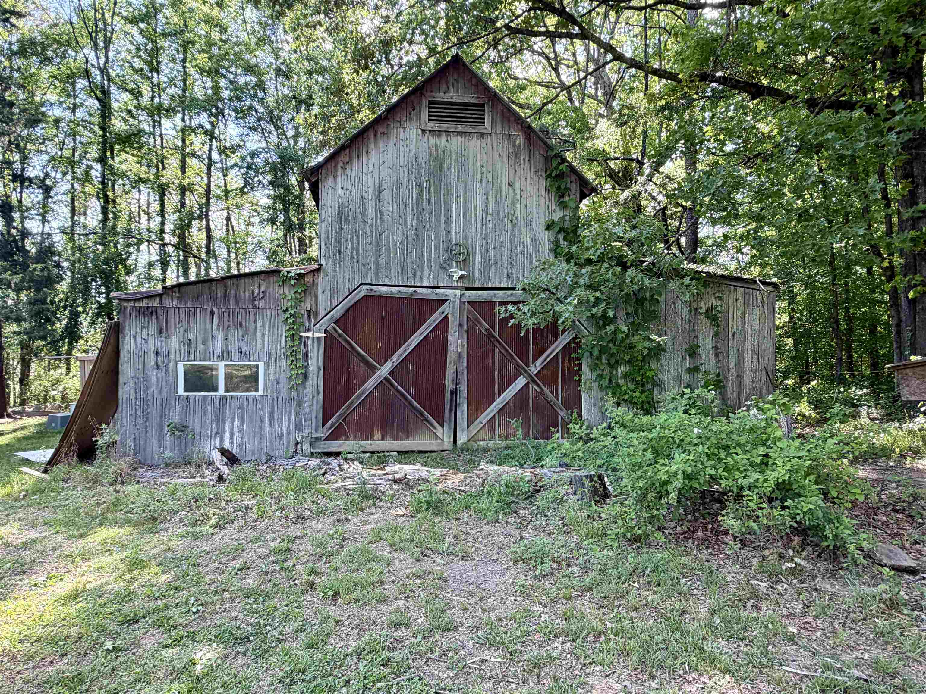 1536 Robinson Shed Road Bethel Springs, TN 38315 - Photo 21 of 23 Rustic wooden barn featuring a gambrel roof and large double doors with X-bracing