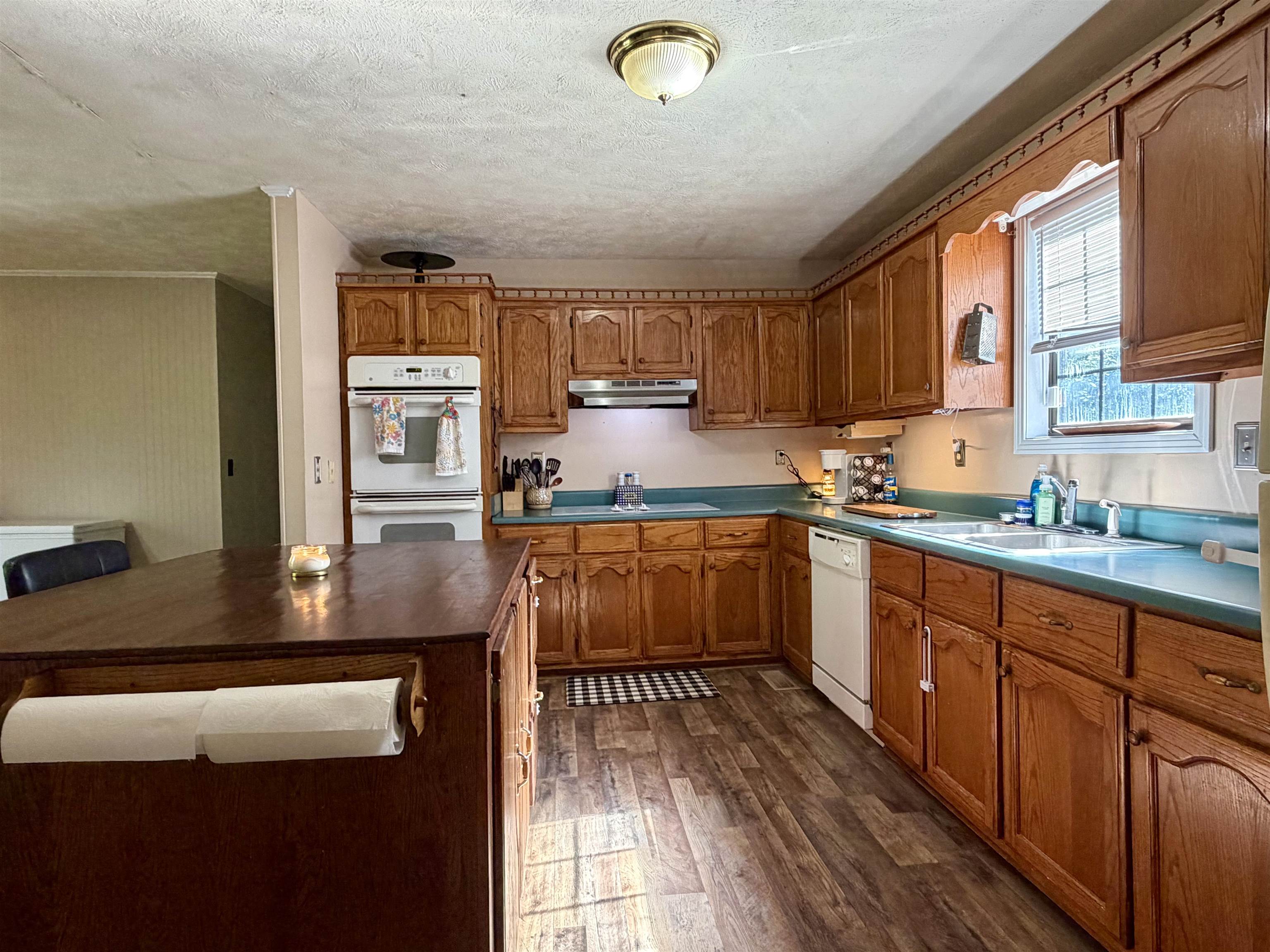1536 Robinson Shed Road Bethel Springs, TN 38315 - Photo 5 of 23 Kitchen featuring wood-finish flooring, oak cabinetry, and integrated double wall ovens