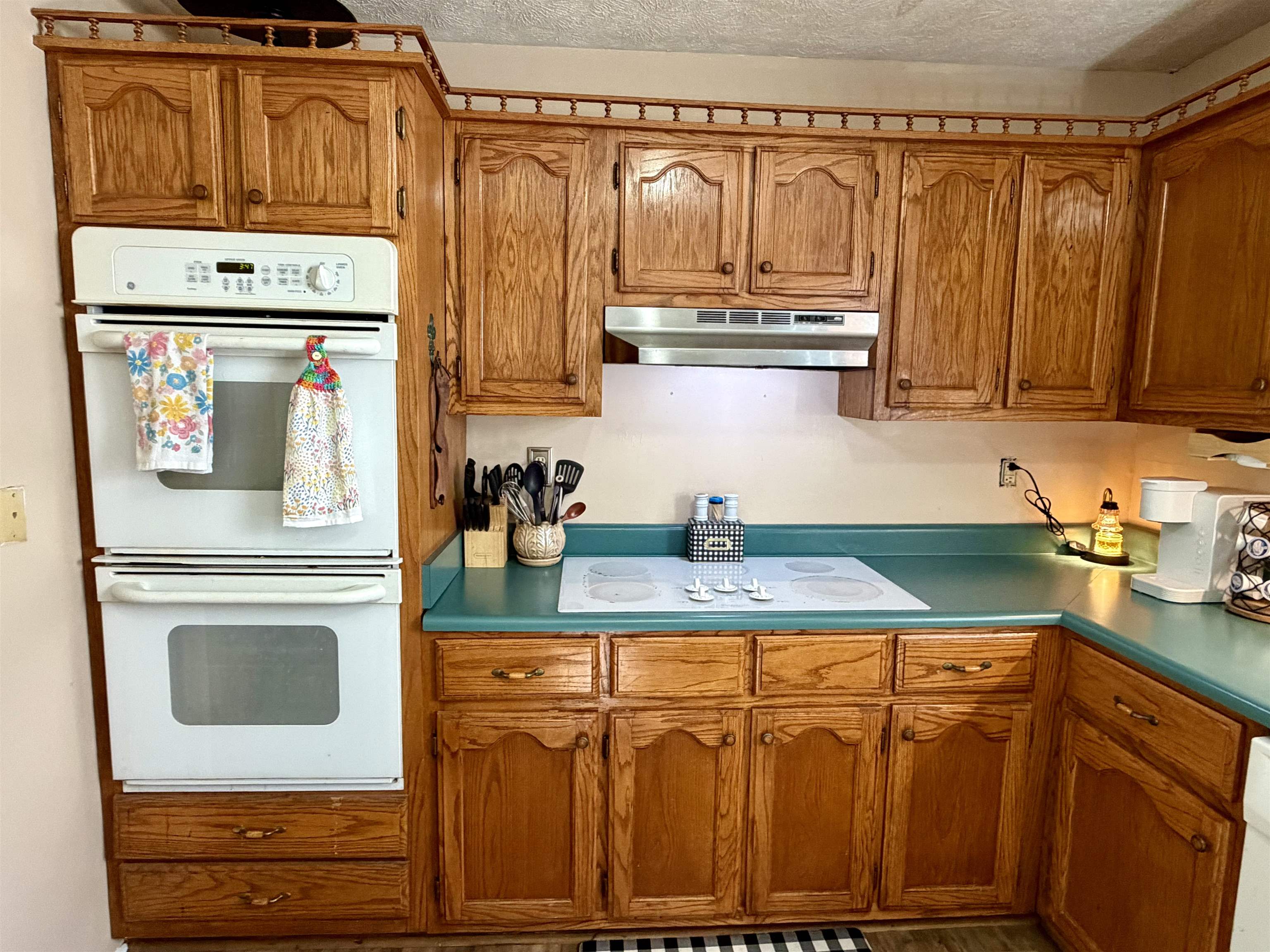 1536 Robinson Shed Road Bethel Springs, TN 38315 - Photo 7 of 23 Kitchen featuring wood cabinetry, a built-in double oven, a smooth cooktop, and a stainless steel range hood