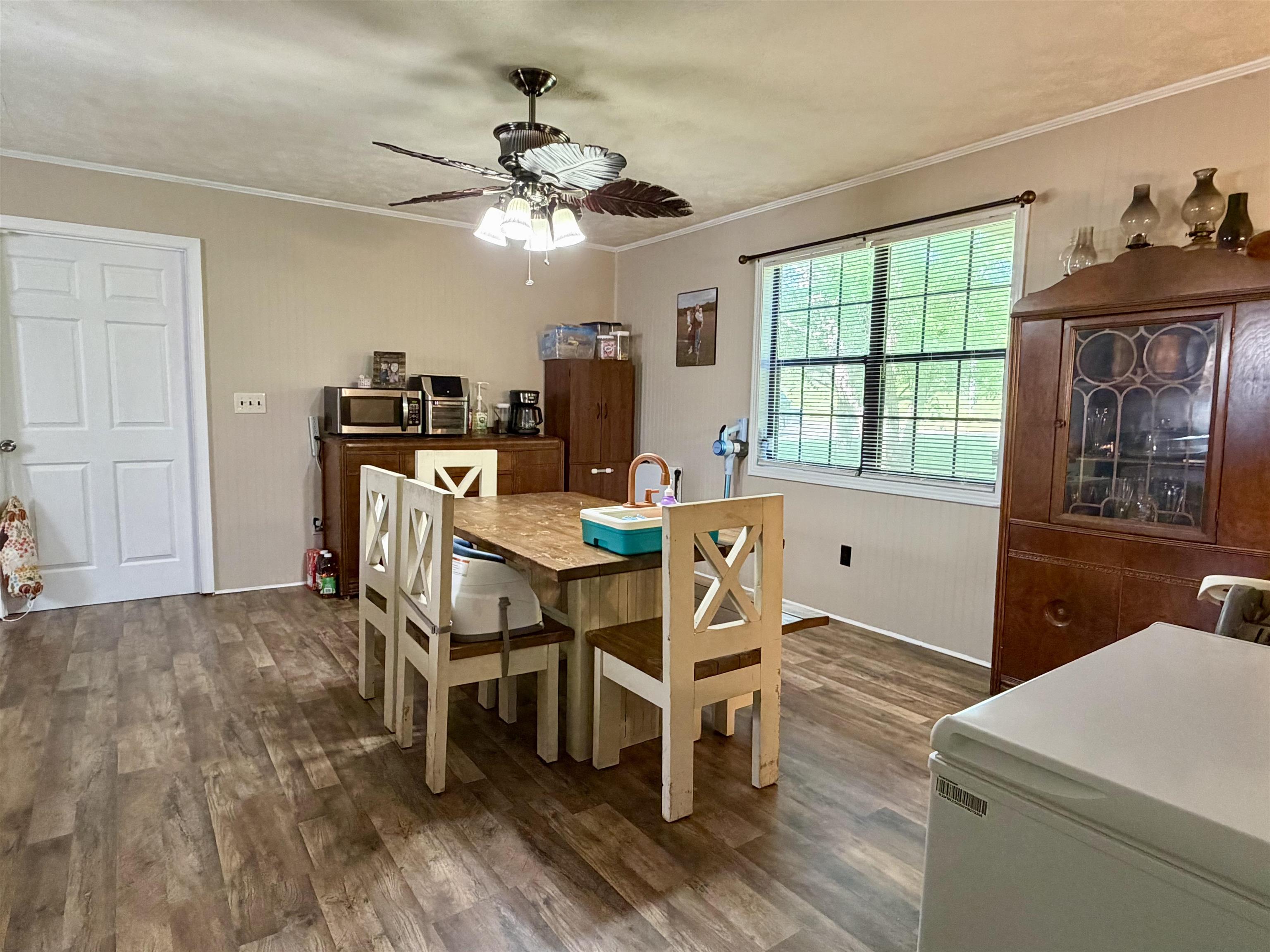 1536 Robinson Shed Road Bethel Springs, TN 38315 - Photo 10 of 23 Spacious room featuring wood-finish flooring, a white paneled door, and a multi-pane window with blinds