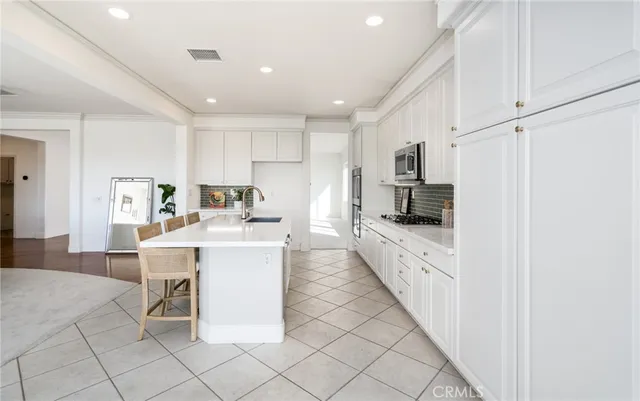 a living room with fireplace furniture and a chandelier