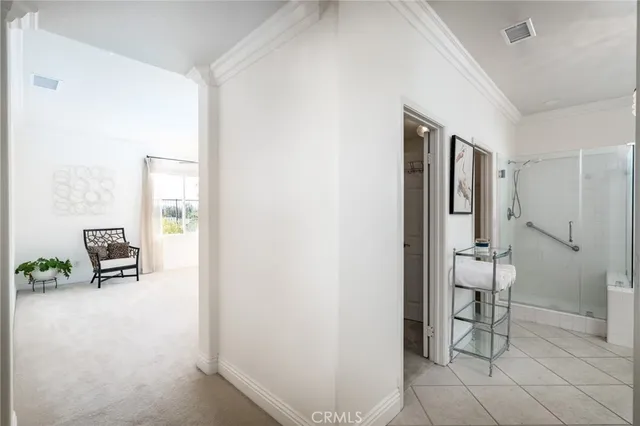 a spacious bathroom with a double vanity sink a mirror a bathtub and shower