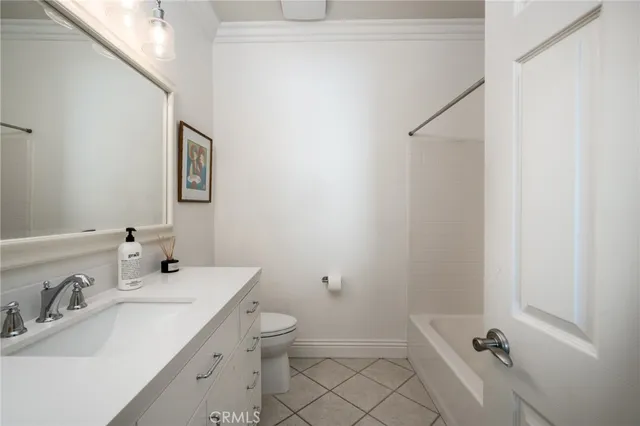 a bathroom with a sink and mirror with toilet