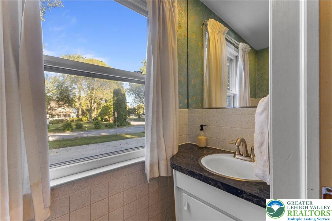 1331 Armstrong Road Bethlehem, PA 18017 - Photo 14 of 28 a bathroom with a granite countertop sink and a large mirror next to a window