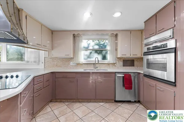 a kitchen with stainless steel appliances granite countertop a sink and cabinets