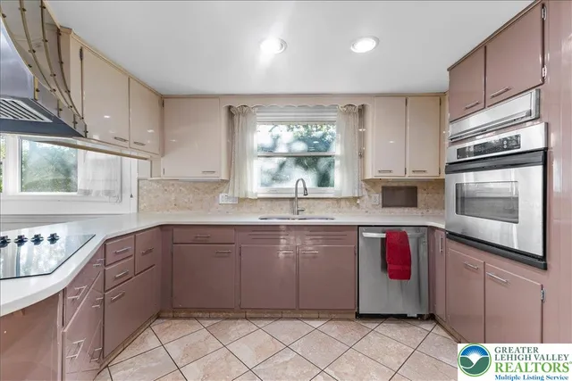 a kitchen with stainless steel appliances granite countertop a sink and cabinets
