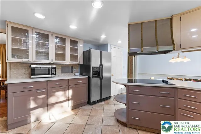 a kitchen with a refrigerator and a sink