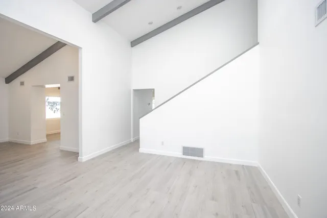 a view of hallway with wooden floor