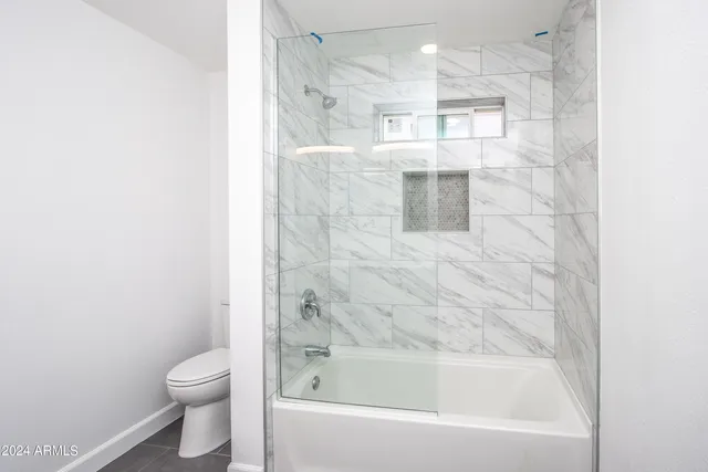 a bathroom with a bathtub and a toilet