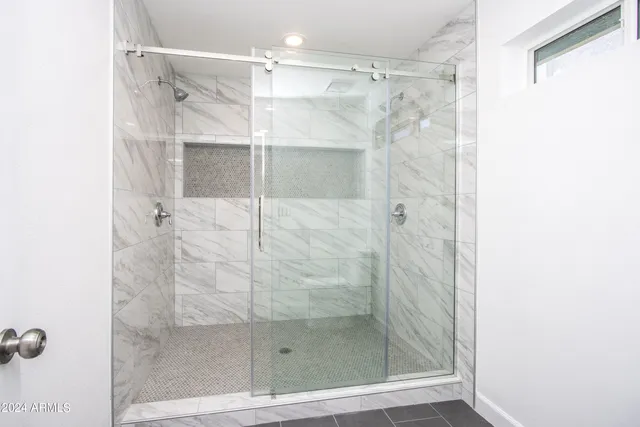 a bathroom with a glass shower door