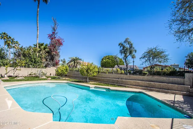 a view of swimming pool with outdoor seating and plants